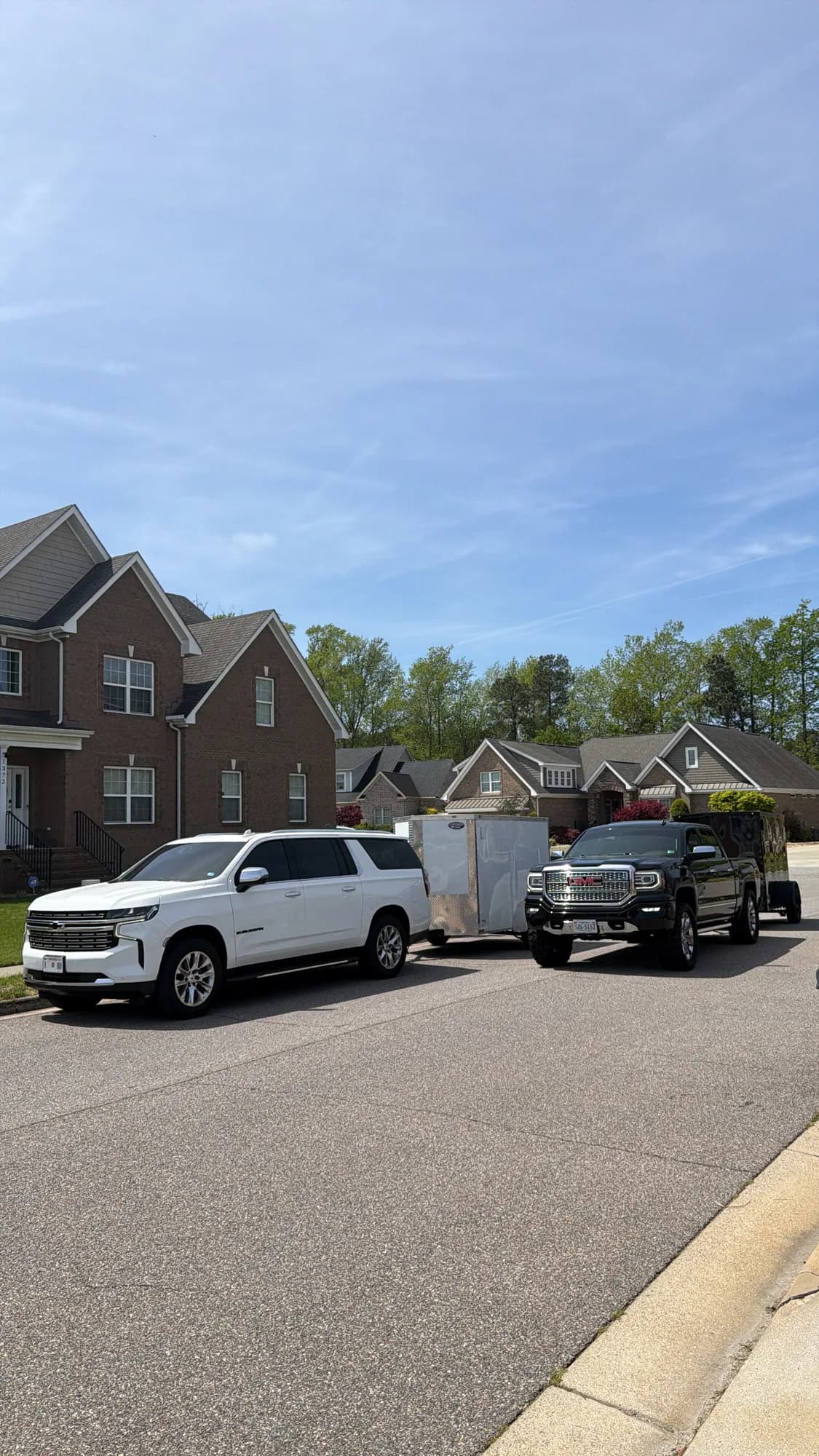 The Blackbird mobile unit and enclosed trailer parked on a residential street in Hampton Roads